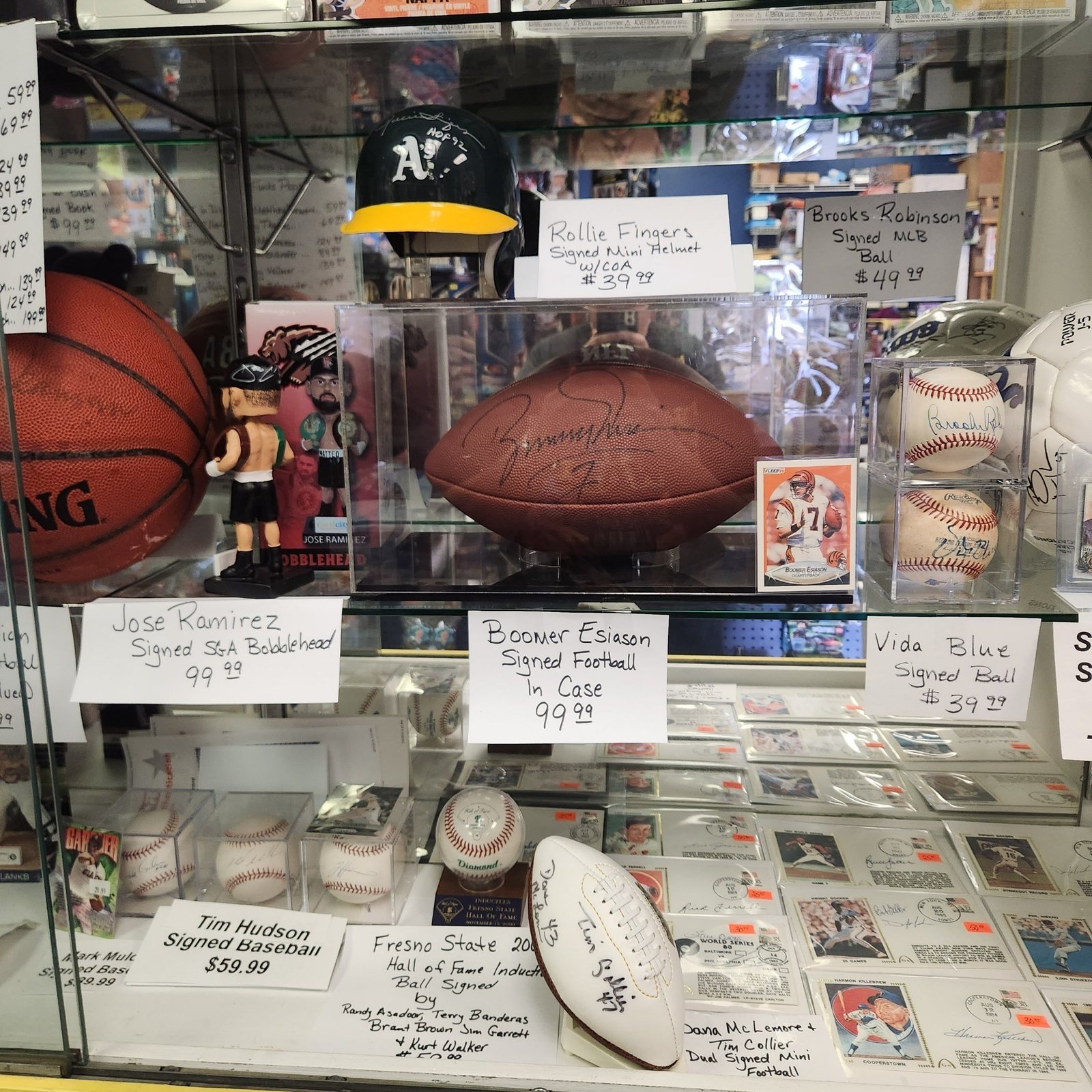 Autographed memorabilia display case with signed baseballs and footballs