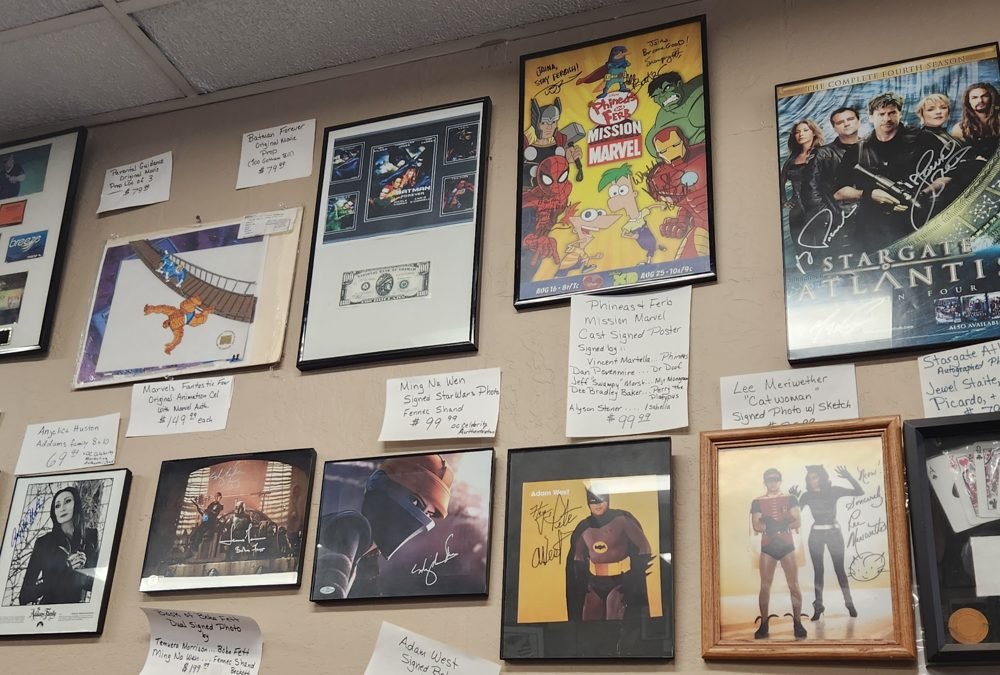 Wall of pop culture posters and framed collectibles